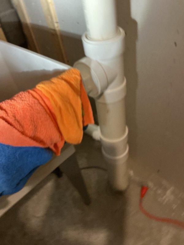 Responded to a water leak underneath the kitchen sink caused by a failing basket strainer on the right side basin. The existing basket strainer had been sealed with plumber's putty that had deteriorated and was no longer maintaining a watertight seal. Removed the old basket strainer assembly and installed a new basket strainer, utilizing silicone sealant instead of putty to ensure a durable, leak-proof connection. Tested the repair to confirm proper drainage and verified no additional leaks were present.