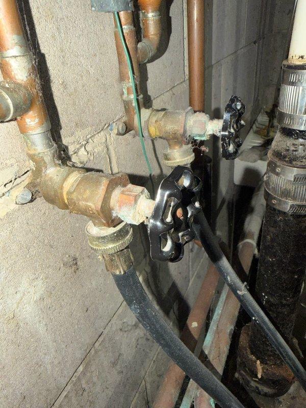 Responded to laundry room plumbing issue where hot and cold water supply valves serving the washing machine were frozen in the open position and actively leaking. Upon inspection, determined that the existing gate valves were seized and could not be repaired. Replaced both laundry supply valves with new shut-off valves featuring black wheel handles, ensuring proper water flow control and eliminating the leak. Tested both hot and cold water lines for proper operation and verified no additional leaks were present at connections.