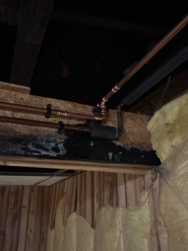 Responded to water leak emergency in basement area. Upon investigation, identified pinhole leak in copper water supply line running from basement to master bathroom. Isolated affected section of compromised copper piping in crawl space area among wooden floor joists. Cut out damaged section of copper pipe containing pinhole perforation. Installed new copper pipe section using proper compression fittings to ensure watertight seal. Tested repaired line for leaks and verified proper water pressure throughout system. Coordinated with restoration company regarding water damage mitigation. All work completed to code standards with system fully operational upon completion.