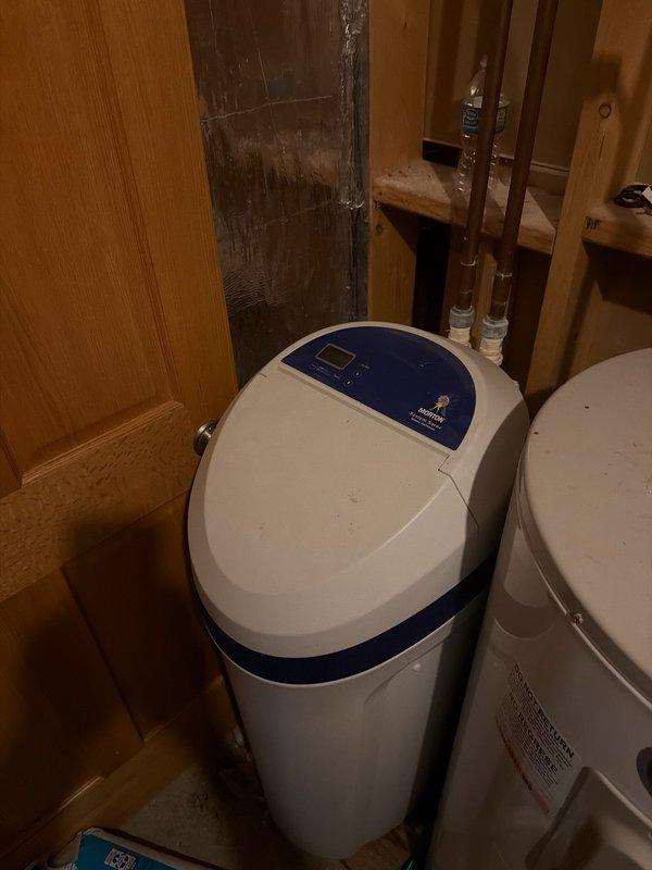 Responded to water softener malfunction with unit constantly running and tank filled with water. Diagnosed failed control head causing continuous operation and improper regeneration cycle. Confirmed leak was intermittent and water supply could remain on during assessment. Scheduled replacement consultation for new control head assembly to restore proper water softening function.