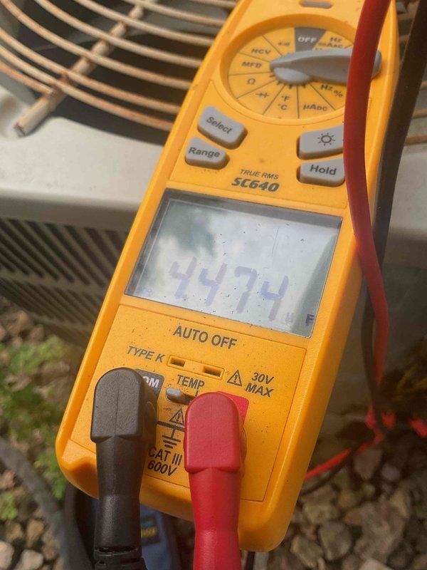 Responded to no cooling call and found system low on refrigerant with capacitor reading 44 microfarads, indicating failure. Upon inspection, discovered severe corrosion and debris accumulation inside capacitor housing with rust throughout electrical connections. Due to unit age and extent of deterioration, recommended full system replacement while providing estimate for capacitor replacement as alternative option.