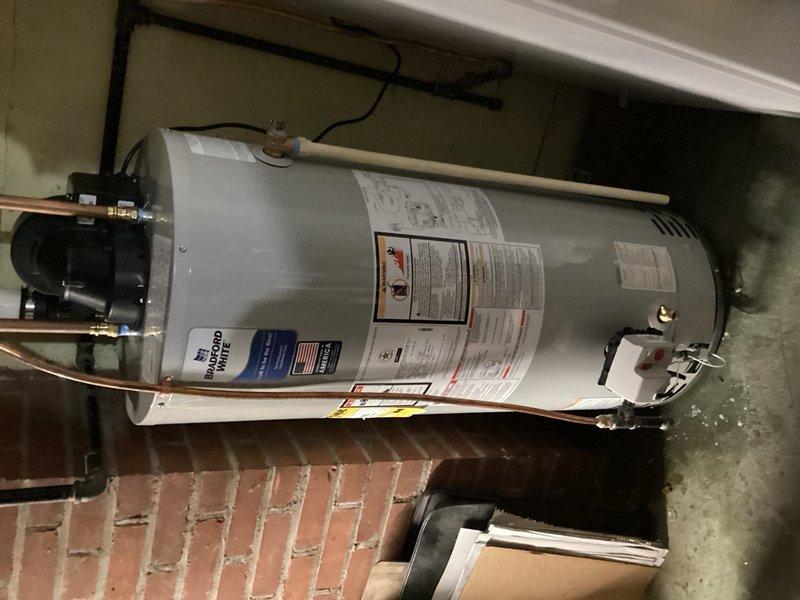 Responded to service call for natural gas water heater that would not start and continuously entered vacation mode. Upon arrival and diagnostic inspection, determined that the 10-year-old unit failed to maintain ignition and would not stay lit. Due to age of equipment and failure to operate reliably, recommended and performed complete water heater replacement. Removed existing failed unit and installed new 40-gallon power vent natural gas water heater. Connected all water supply lines, gas line, and venting system per manufacturer specifications and local code requirements. Tested new installation for proper ignition, combustion, and venting operation. Verified all connections for leaks and confirmed unit cycled properly through heating modes. System restored to full operation with reliable hot water delivery.