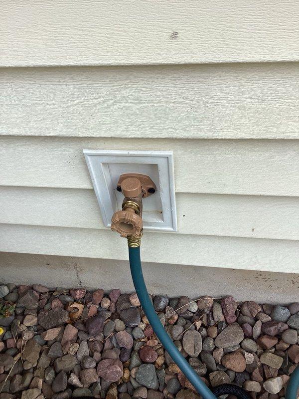 Responded to a water leak complaint at the front exterior hose bib that was recently installed. Upon inspection, identified that the bonnet nut on the brass hose bib was loose, causing water to leak when the faucet was turned on. Tightened the bonnet nut to manufacturer specifications, resolving the leak issue and restoring proper function to the outdoor faucet.