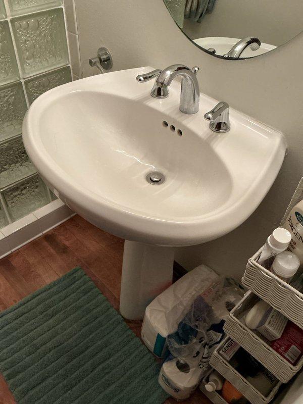 Responded to service call for installation of two customer-supplied faucets. Upon arrival, diagnosed existing fixtures and confirmed both required replacement due to operational failures. The bathroom faucet, approximately 15 years old, exhibited continuous water flow even with shutoff valve closed, indicating internal valve seat failure. The kitchen faucet, approximately 5 years old, displayed loose handle assembly compromising proper operation.

In the bathroom, removed existing three-hole faucet assembly from pedestal sink. Installed replacement chrome three-piece faucet set with central spout and dual lever handles onto sink deck. Connected hot and cold water supply lines to respective valve stems, ensuring proper thread seal with appropriate tape and compound. Installed new pop-up drain assembly, making secure connections to tailpiece and P-trap configuration. Restored water supply and conducted operational testing of both hot and cold water delivery. Verified lever handle operati