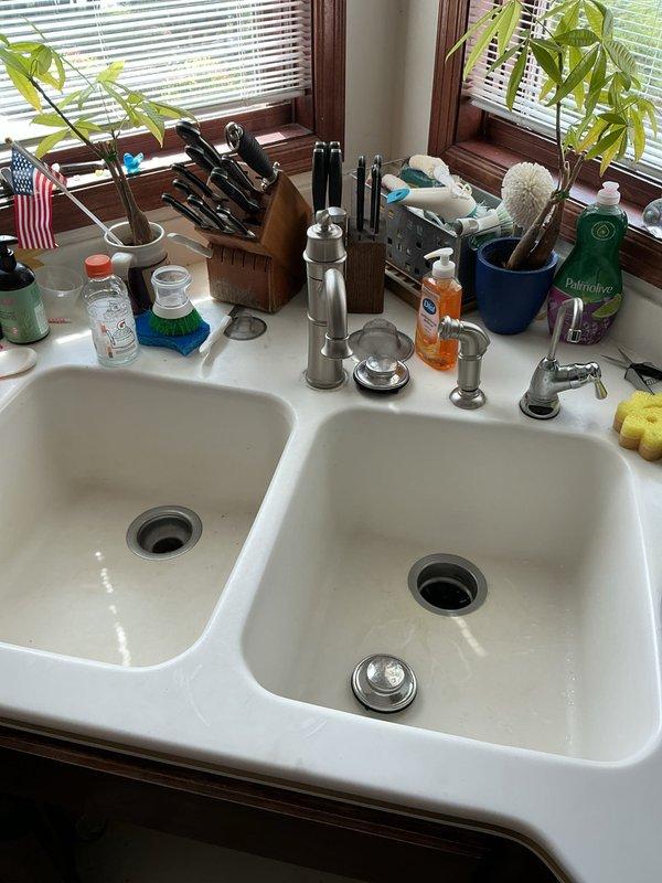 Responded to service call for installation of two customer-supplied faucets. Upon arrival, diagnosed existing fixtures and confirmed both required replacement due to operational failures. The bathroom faucet, approximately 15 years old, exhibited continuous water flow even with shutoff valve closed, indicating internal valve seat failure. The kitchen faucet, approximately 5 years old, displayed loose handle assembly compromising proper operation.

In the bathroom, removed existing three-hole faucet assembly from pedestal sink. Installed replacement chrome three-piece faucet set with central spout and dual lever handles onto sink deck. Connected hot and cold water supply lines to respective valve stems, ensuring proper thread seal with appropriate tape and compound. Installed new pop-up drain assembly, making secure connections to tailpiece and P-trap configuration. Restored water supply and conducted operational testing of both hot and cold water delivery. Verified lever handle operati