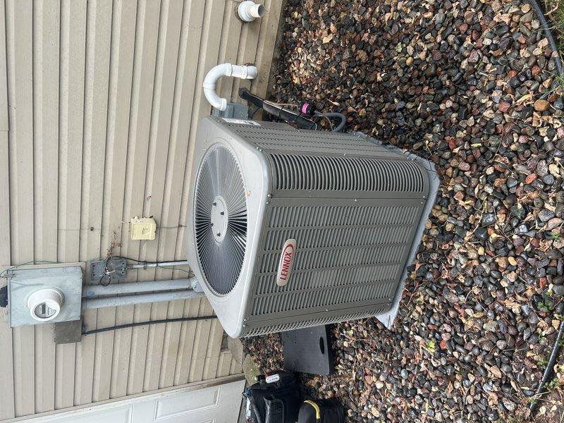 Completed comprehensive furnace and air conditioning tune-up for residential HVAC system. Tested furnace operation, verified gas pressure within manufacturer specifications, and confirmed proper temperature rise across heat exchanger. Inspected and cleaned flame sensor, checked all furnace components for proper operation, and verified air filter condition and condensate drain functionality. Switched system to cooling mode and performed exterior condenser maintenance including coil washing to remove debris and buildup. Measured refrigerant pressures and temperatures on Lennox condenser unit, confirming system operating within normal parameters. Verified proper operation of compressor, fan motor, and electrical connections. Checked condensate drain lines for both units, ensuring clear drainage. All components tested and found operating correctly with no immediate repairs needed. Provided customer with information regarding available duct cleaning services and UV light air purification op