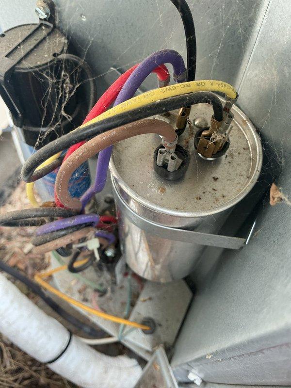 Responded to no-cool complaint on 11-year-old Daikin air conditioning system that experienced unusual noise during nighttime operation before shutting down, with outdoor fan continuing to run. Diagnostic testing confirmed dual component failure: capacitor and compressor both inoperative. Documented failed components with photographic evidence showing capacitor with multiple wire connections and accumulated debris within electrical compartment. Submitted parts order form for warranty compressor replacement pricing and estimate, provided estimate for complete system replacement scheduled for customer review.