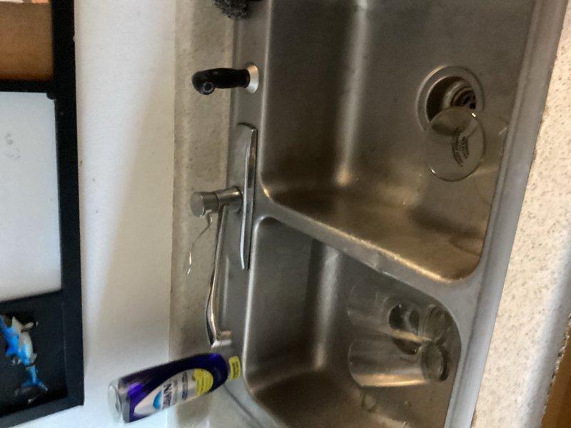 Responded to plumbing service call at a restaurant with attached apartment unit. Assessed leaking upstairs drain and provided estimate for faucet replacement. Successfully replaced bathroom faucet and drain assembly with new fixtures. Installed new stainless steel double-basin kitchen sink with single-handle chrome faucet, including all supply lines and drainage connections. All water supply connections secured with braided flexible supply lines and shut-off valves. Tested all fixtures for proper operation and verified no leaks present upon completion.