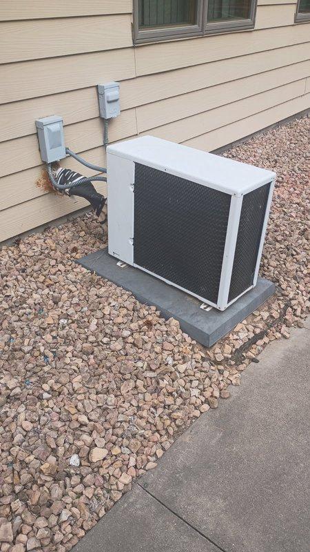Responded to no cooling complaint on multi-zone mini split system. Upon arrival, verified upstairs indoor head unit fan operational but blowing warm air while main floor unit cooling properly. Inspected both indoor head units, confirmed filters and evaporator coils clean and unobstructed. Proceeded to outdoor condenser unit for diagnostic evaluation. Inspected condenser coil for blockage or debris, found satisfactory. Performed electrical testing on capacitors and identified failed 20 MFD capacitor reading below manufacturer specifications. Replaced defective capacitor with OEM equivalent part. Restored power and cycled system through complete operational test. Verified upstairs head unit now delivering proper cooling temperatures and airflow. Confirmed both zones operating within normal parameters before clearing service call.