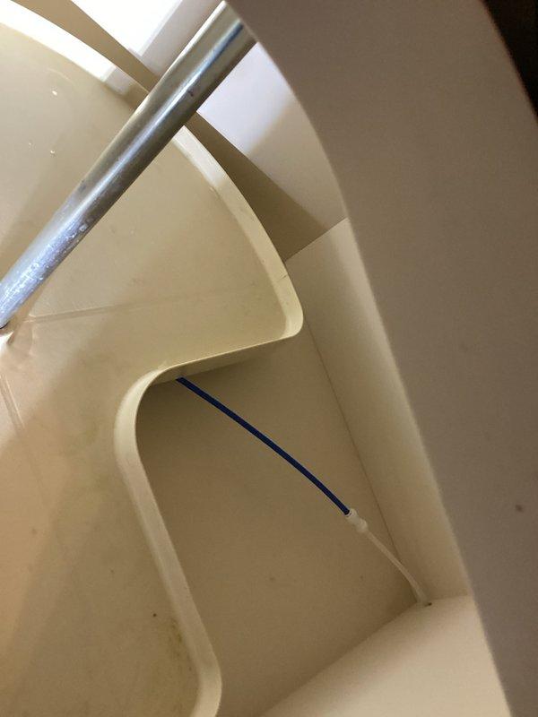 Responded to emergency service call for severed refrigerator water supply line located under kitchen lazy Susan cabinet. Upon arrival, found active water leak filling multiple 5-gallon buckets after a plate had fallen and completely cut the drinking water line. Shut off water supply to refrigerator to stop flooding. Removed damaged section of water line that had been cleanly severed. Installed new water line section, coupled connections together securely, and properly fastened and secured line within lazy Susan cabinet to prevent future damage. Tested system for proper operation and verified no additional leaks present.