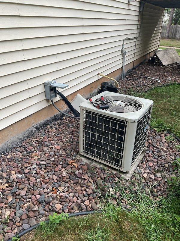 Responded to no cooling call on residential air conditioning system. Found condenser fan motor seized and buzzing but not rotating. Unit identified as approximately 30 years old. Documented failed motor with photographs for replacement part matching. Provided estimate for condenser fan motor replacement, noting shaft will require cutting for removal. Due to advanced age of system, recommended obtaining estimate for complete system replacement and coordinated sales consultation through office.