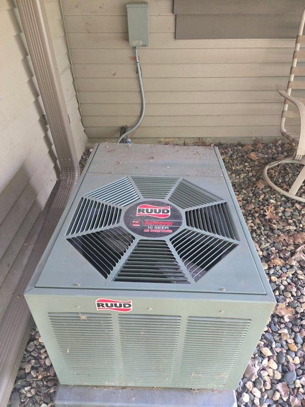 Responded to no cooling call on 10+ year old Ruud R-22 system. Verified thermostat operation normal. Inspected outdoor unit and found contactor failed - confirmed 240V and 24V power supply present but no 240V output to compressor circuit. Replaced defective contactor and restored system operation. Initial temperature split measured only 7 degrees across evaporator coil. Identified heavily soiled air filter restricting airflow and replaced with new filter. Found outdoor condenser coil significantly clogged with dirt and debris. Performed coil cleaning by rinsing down outdoor unit. Rechecked temperature split after cleaning, which improved to 15 degrees, confirming restored cooling efficiency. System now operating within normal parameters.