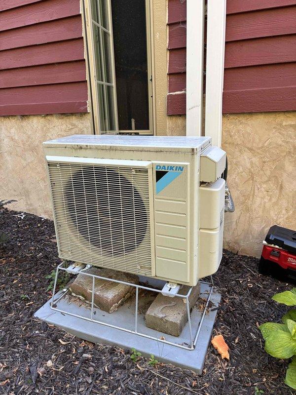 Responded to no-cool complaint on dual-zone mini-split system. Found drain pan full and overflowing due to completely plugged condensate drain line causing water leakage from indoor unit. Cleared blockage by vacuuming drain line from exterior termination point with shop vac, then flushed drain pan and verified proper drainage restored. During inspection, observed both indoor air handler blower wheels and evaporator coils were heavily contaminated with debris buildup restricting airflow. System returned to normal operation after drain line service. Provided estimate for comprehensive cleaning of both indoor heads due to excessive dirt accumulation affecting system performance and efficiency.