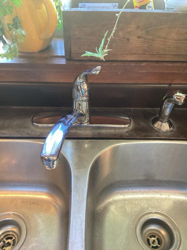 Responded to emergency water leak under kitchen sink caused by failed hot water supply line connecting faucet to shut-off valve. Upon arrival, water supply to home had been shut off to prevent further damage. Removed existing kitchen faucet assembly and disconnected failed supply hose. Installed new single-handle kitchen faucet with chrome finish, including complete supply line replacement to both hot and cold water connections. Verified all connections for proper seal, restored water supply, and tested faucet operation to ensure no leaks and proper functionality.
