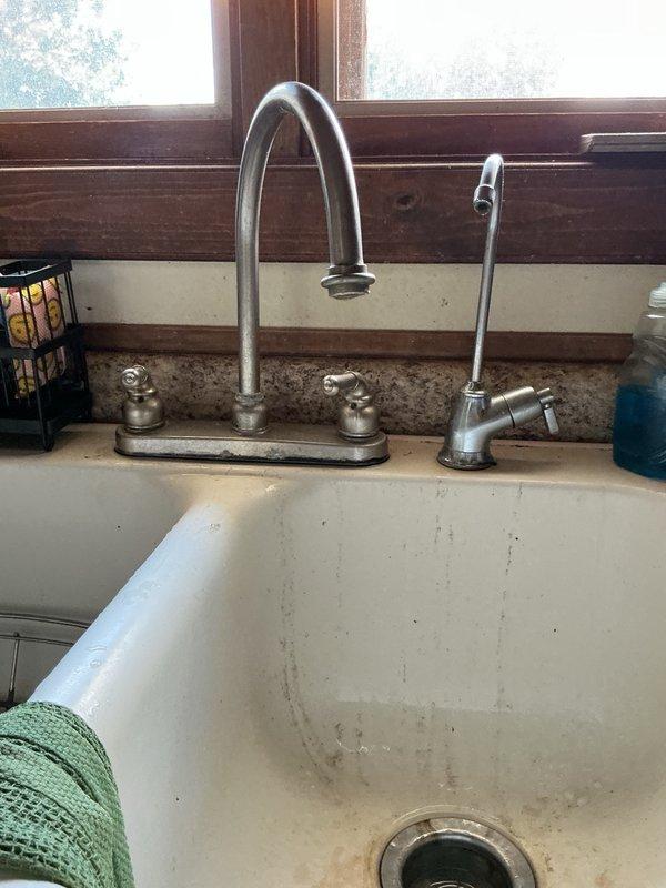 Responded to emergency call for burst pipe under kitchen sink. Upon inspection, discovered the drinking water filter was leaking and had caused significant water damage, with the sink base cabinet completely rotted out from prolonged moisture exposure. Disconnected the drinking water faucet assembly and installed new shut-off valve on the cold water supply line. Replaced deteriorated supply line to cold side of kitchen faucet and tested all connections. Verified no leaks present after repairs and system restored to full operation.