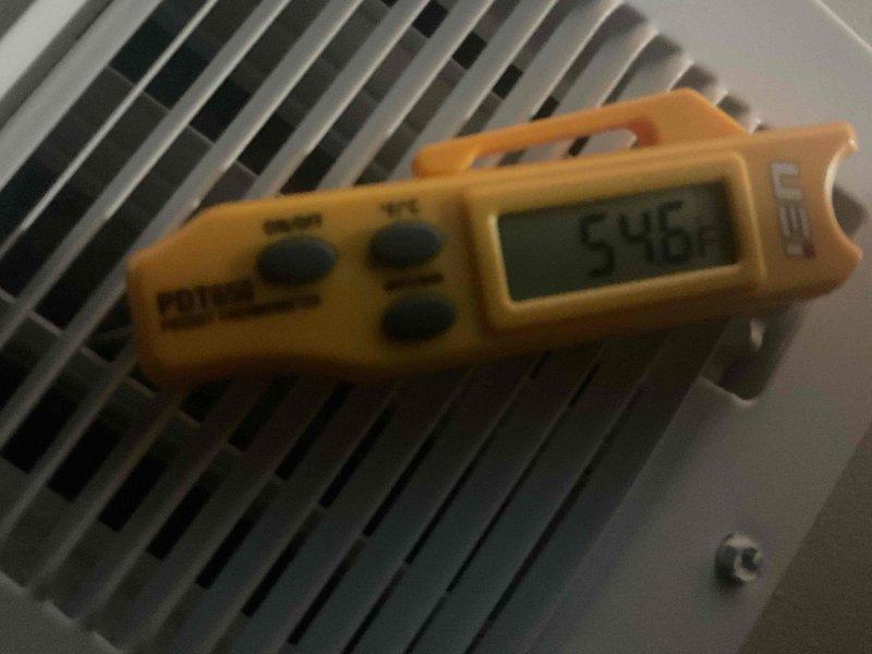 Responded to airflow concerns and performed comprehensive ductwork inspection using camera scope to identify potential blockages. Investigated hidden dampers concealed above ceiling tiles, opened closed dampers to restore proper airflow, and measured supply air temperatures at multiple registers, recording readings of 54.6°F and 59.8°F to verify system performance after adjustments.