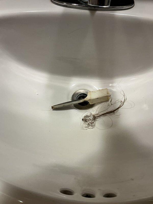 Responded to service call for low water pressure in shower and stuck lavatory strainer. Removed and cleaned clogged flow restrictor from shower head, restoring proper water pressure. Replaced stuck lavatory strainer with new unit to restore proper drain function. Addressed bathtub diverter malfunction preventing switching from tub spout to shower mode, completing all necessary repairs to restore full functionality of bathroom fixtures.