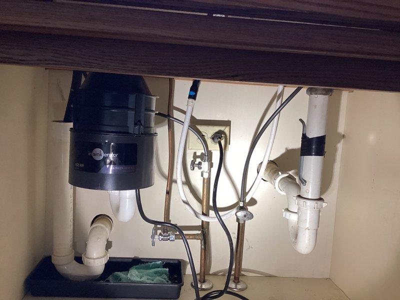 Responded to service call for malfunctioning garbage disposal that had failed over the weekend. Upon inspection, found unit was producing loud, clunky noises and had rusted through the housing. Removed failed disposal unit and installed new InSinkErator replacement, ensuring proper mounting, electrical connections at breaker panel, and plumbing integration with existing PVC drain system and P-trap configuration.