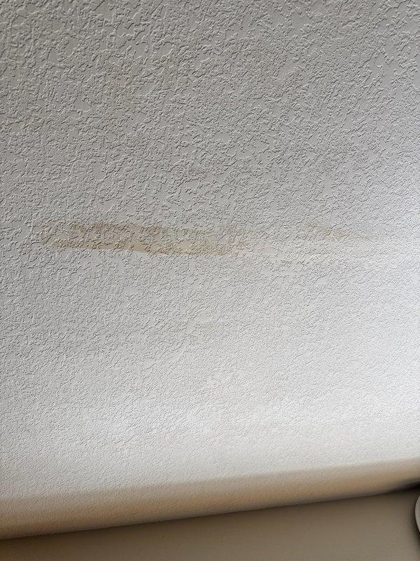 Responded to water leak complaint with visible ceiling damage in kitchen area directly below master bathroom shower. Upon investigation, determined leak was isolated to shower usage only. Inspection revealed improperly closing shower door allowing water to escape containment area, run down shower curb, and accumulate on tile floor. Water penetration occurred through grout lines and substrate, migrating to ceiling below. Performed exploratory opening in kitchen ceiling to confirm moisture source and verify water damage location corresponded with shower curb position. Documented conditions with photographic evidence showing ceiling water staining and bathroom floor conditions including moisture accumulation near shower door track. Advised property owner that shower door requires adjustment or replacement to establish proper seal and prevent continued water escape. No plumbing system defects identified; issue attributed solely to shower enclosure door malfunction allowing water bypass dur