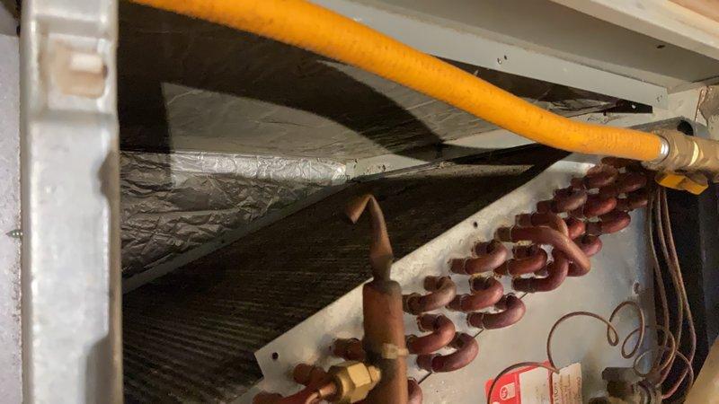 Responded to service call at mobile home to assess HVAC system in closet location. Upon arrival, discovered significant structural damage with rotted flooring beneath 2018 90% efficiency furnace and evaporator coil assembly. Evaluated existing R-410A air conditioning system and furnace with PVC venting installed through metal roof. Documented extensive deterioration of subfloor requiring structural repairs before equipment can be safely supported. Photographed PVC vent terminations extending above roofline, internal furnace components including heat exchanger coils, refrigerant lines, gas line connections, and electrical wiring configurations. Assessed equipment removal requirements to allow access for floor replacement work. Equipment will need complete disconnection of gas supply, electrical connections, refrigerant lines, condensate drainage, and PVC vent piping for temporary removal. Prepared photographic documentation of existing installation configuration to facilitate proper rei