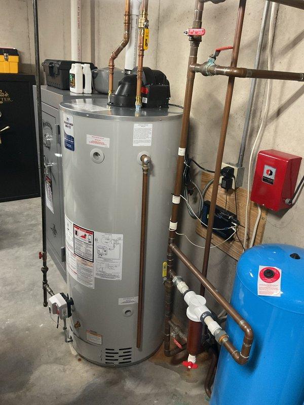 Completed comprehensive maintenance tune-up on 7-month-old geothermal heat pump system with in-floor heating zones. Verified operation of geothermal unit, measured loop and load side pressures and temperatures with satisfactory 20-degree temperature differential across system. Tested capacitor reading 27.5 microfarads, slightly below rated 30 microfarads but within acceptable operating range. Inspected and confirmed proper operation of all zone valves controlling in-floor radiant heating system. Performed standard preventive maintenance procedures per agreement requirements, including visual inspection of mechanical room equipment, water heater connections, pressure tank, and associated plumbing components.
