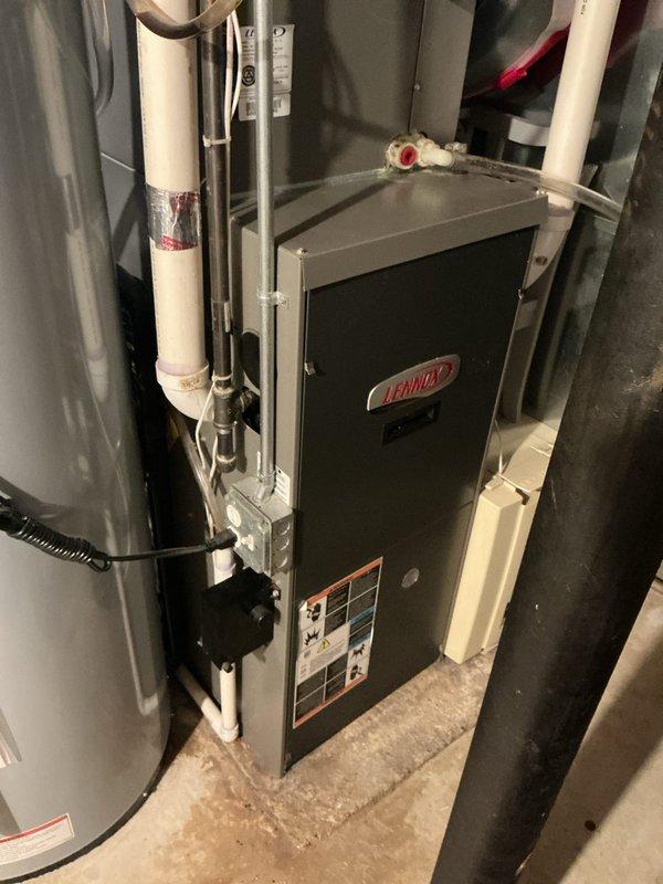 Performed cooling system maintenance on 19-year-old air conditioning unit and identified failing capacitor and contactor, though refrigerant levels remain adequate and system is currently operational. During inspection, discovered critical safety issue: furnace heat exchanger has crack around eyelet in top/right cell past high limit switch, causing carbon monoxide leak during operation. Red-tagged furnace as unsafe to operate and scheduled replacement estimate for both furnace and air conditioning system due to age and condition of equipment.