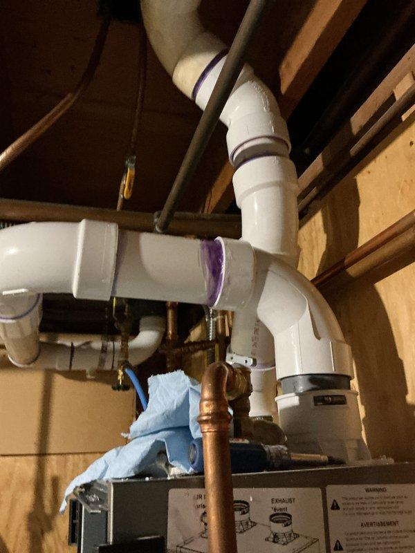 Responded to callback for boiler installed in January experiencing intermittent disconnection of large exhaust pipe above unit. Upon inspection, discovered the flue connection pipe was not properly glued during initial installation, causing the pipe to come loose and leak. Applied proper PVC cement to secure the flue connection and tested system for proper operation and seal integrity.