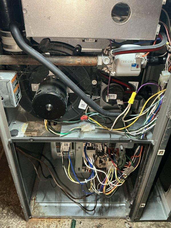 Responded to no cool complaint on residential HVAC system installed in 2021. Upon inspection, diagnosed failed furnace blower motor preventing air circulation through the system. Motor failure confirmed through visual inspection and operational testing. Unit components and wiring harness photographed for documentation. Blower motor determined to be covered under parts warranty as unit is less than ten years old. Special order replacement motor required due to specific model specifications. Customer notified that replacement motor will be ordered and installation will be scheduled upon arrival of the part.