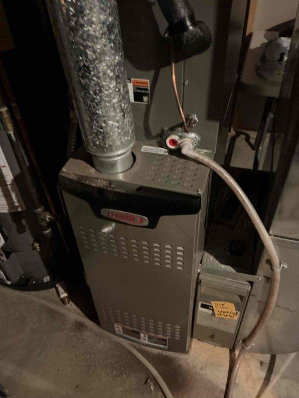 Installed a 45-degree B-vent elbow on the Lennox furnace to properly adjust exhaust vent direction while maintaining adequate airflow. Secured all exhaust vent sections with appropriate fasteners, as the existing vent pipe segments were improperly installed without screws and not adequately connected. All exhaust components now properly fastened and secured to manufacturer specifications.