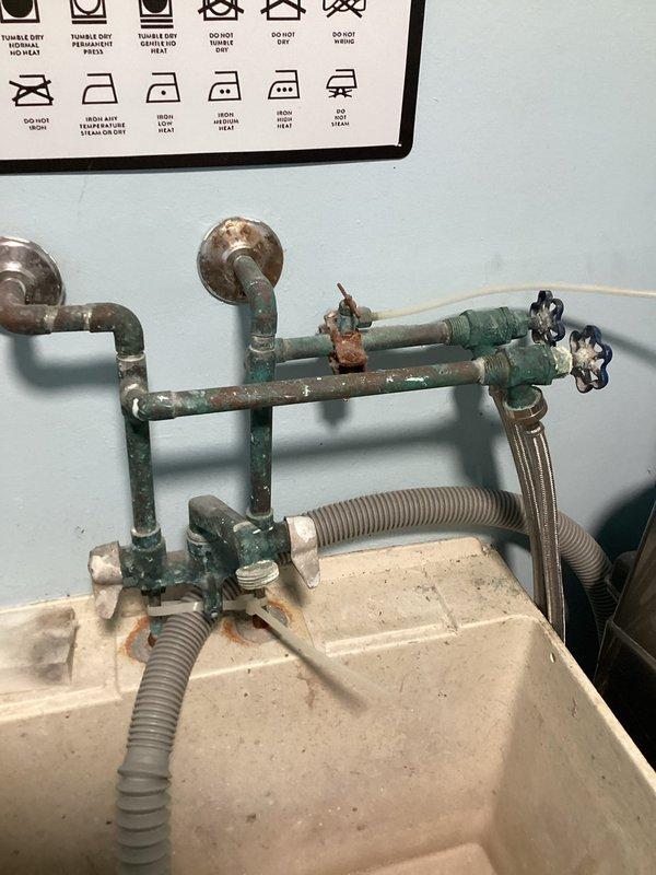 Responded to service call for leaking outdoor hose bib and non-functional laundry valves. Upon inspection, determined the exterior hose bib required full replacement due to leak and the laundry room shut-off valves were seized and inoperable from corrosion. Successfully replaced the outdoor hose bib with new fixture and replaced both corroded laundry valves to restore proper water control functionality.