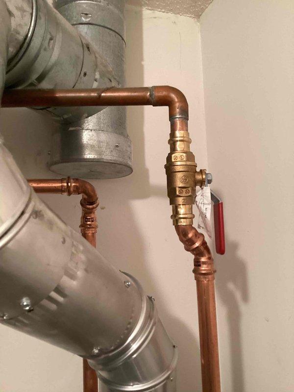 Responded to service call for leaking water heater requiring immediate replacement. Upon inspection, confirmed the existing unit had failed and was actively leaking, necessitating full replacement to restore hot water service and prevent water damage.

Shut off water supply and gas line to the failed unit. Drained the existing water heater completely and disconnected all water inlet and outlet lines, gas supply line, and exhaust ventilation. Removed the old unit from the installation location and prepared the area for new equipment installation.

Installed a new Bradford White 40-gallon tall natural draft water heater as a direct replacement. Reconnected the cold water inlet line and hot water outlet line using existing copper piping with brass ball valve for isolation capability. Reconnected the natural gas supply line to the new unit's gas control valve, ensuring proper threading and gas-tight connections. Reattached the exhaust vent piping to direct combustion gases safely outside t