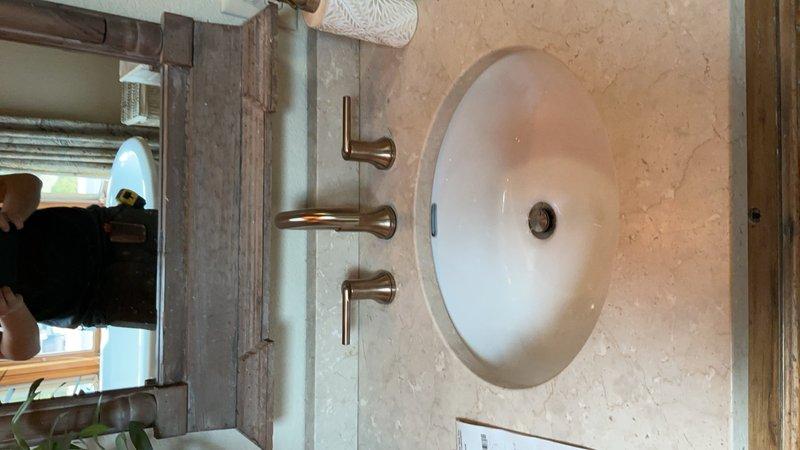Completed installation of two customer-supplied widespread lavatory faucets with wall-mounted fixtures and handles in brushed nickel finish. Replaced existing shower valve, spout, and trim assembly utilizing existing access from behind the valve. All installations tested for proper operation and verified leak-free connections upon completion.
