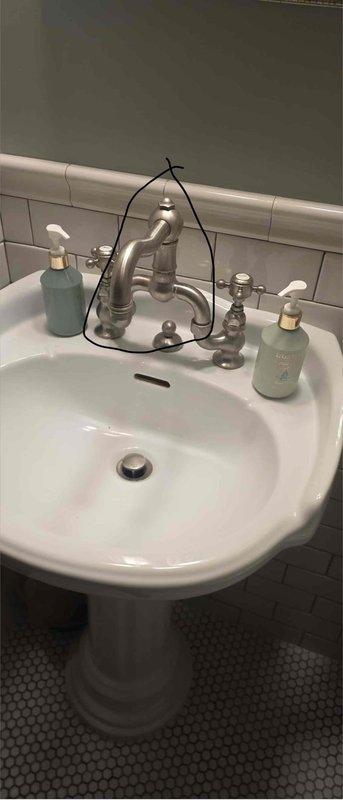 Responded to service call for two bathroom faucet issues including one leaking faucet and one leaking connection with no hot water supply. Inspected white pedestal sink with brushed nickel two-handle faucet fixture and identified water leak requiring repair. Assessed both faucet assemblies, diagnosed necessary repairs, and documented conditions with photographs. Provided estimates for required parts and arranged for ordering of components needed to complete repairs.