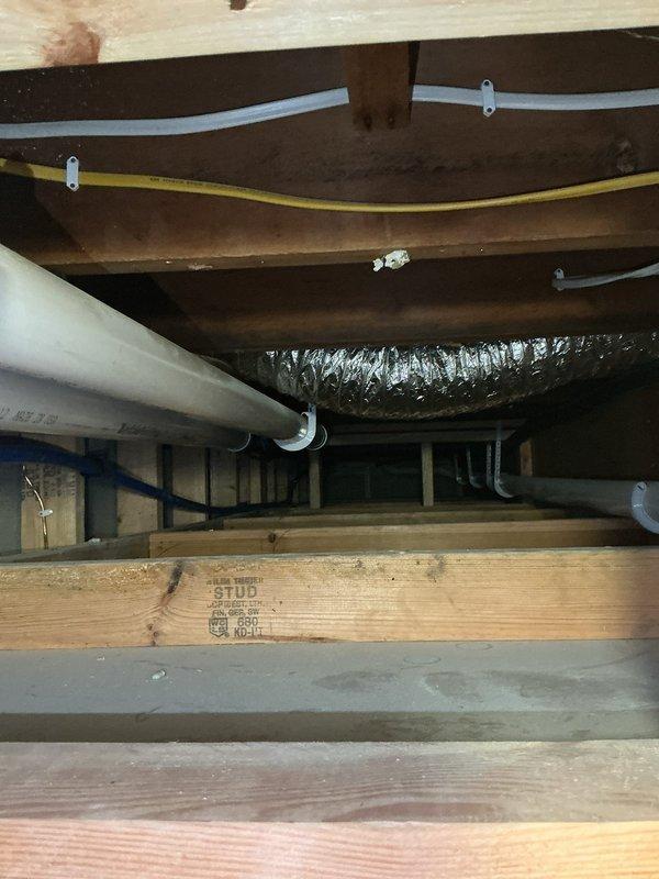 Responded to no-cool service call and discovered A/C unit completely non-operational due to missing or disconnected control wiring. Upon inspection, found the fan wire disconnected from the furnace and the 2-wire communication cable between the outdoor condenser and indoor air handler either removed or never properly installed. Additionally identified missing or improperly installed 4-wire thermostat wiring from basement to furnace. Documented wiring deficiencies with photographs showing debris accumulation in furnace cabinet and crawl space conditions where new wiring will need to be fished. Prepared estimate for running new 2-wire from outdoor unit across ceiling to furnace and installing new 4-wire thermostat cable, coordinating with electrician for wire fishing and installation to restore system functionality and enable operational testing.