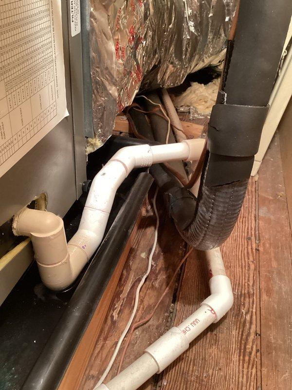 Responded to second callback on recently installed air conditioning system that had shut down due to moisture infiltration. Upon inspection, discovered missing vent after condensate trap, standing water in drain pan and fan coil pan, and debris accumulation in evaporator tray. Extracted approximately two gallons of water from condensate drain line running to third floor, which contained significant old buildup causing blockage. Installed proper vent after trap per code requirements, thoroughly cleared drain line, removed debris from evaporator tray, and verified refrigerant charge was within specifications. Operated system through complete cooling cycle to confirm proper condensate drainage and unit functionality before departure.
