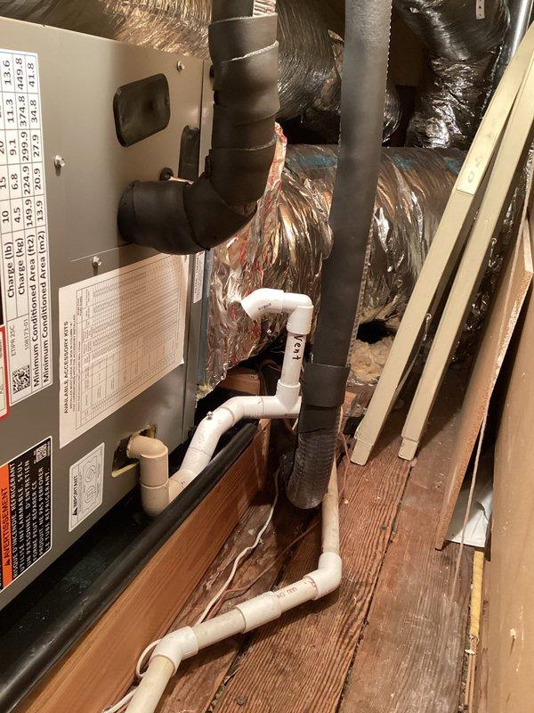 Responded to second callback on recently installed air conditioning system that had shut down due to moisture infiltration. Upon inspection, discovered missing vent after condensate trap, standing water in drain pan and fan coil pan, and debris accumulation in evaporator tray. Extracted approximately two gallons of water from condensate drain line running to third floor, which contained significant old buildup causing blockage. Installed proper vent after trap per code requirements, thoroughly cleared drain line, removed debris from evaporator tray, and verified refrigerant charge was within specifications. Operated system through complete cooling cycle to confirm proper condensate drainage and unit functionality before departure.