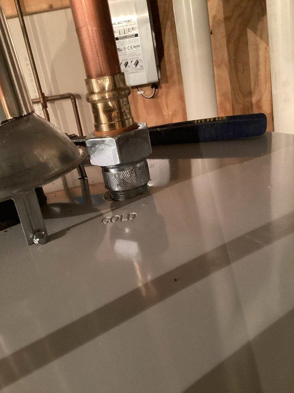 Responded to callback for water heater installed previous day with reported leak of unknown origin. Upon arrival, no standing water was visible on floor. Conducted thorough inspection of all unions and connections on the water heater system. Identified slow leak at cold water inlet dielectric union. Tightened the cold inlet dielectric fitting to proper torque specification, which resolved the leak. System tested and confirmed no further water seepage present.