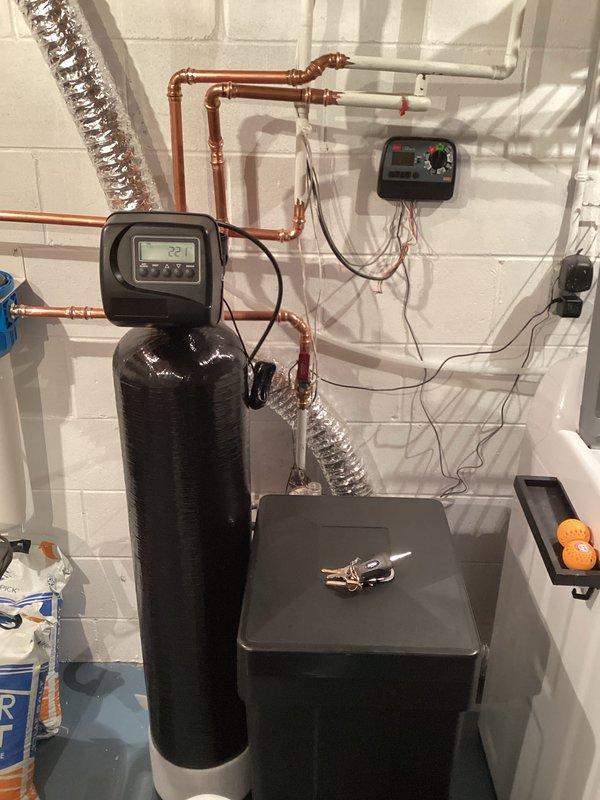 Responded to callback for water heater installed previous day with reported leak of unknown origin. Upon arrival, no standing water was visible on floor. Conducted thorough inspection of all unions and connections on the water heater system. Identified slow leak at cold water inlet dielectric union. Tightened the cold inlet dielectric fitting to proper torque specification, which resolved the leak. System tested and confirmed no further water seepage present.