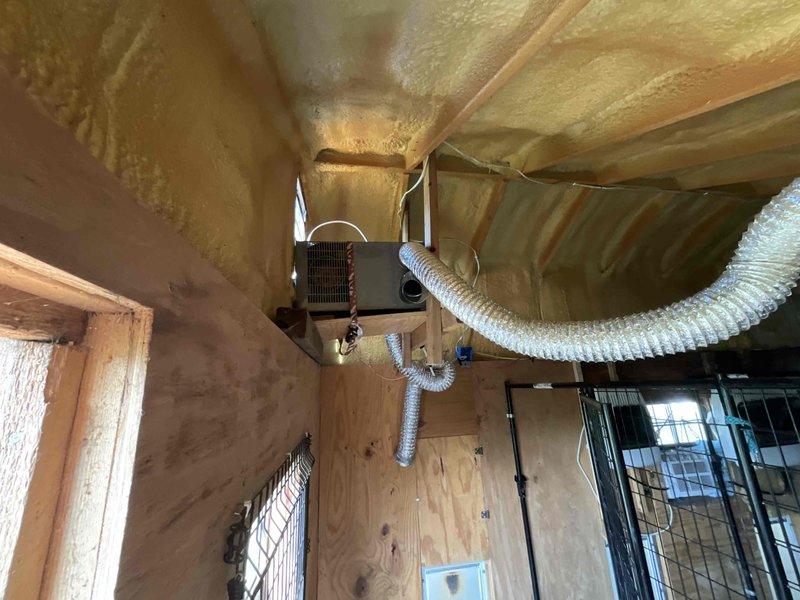 Contacted client to schedule boiler installation with preference for Thursday appointment to coordinate with existing scheduled service visit. Documented exterior work area showing access points and interior attic space with existing HVAC ductwork and spray foam insulation for installation planning purposes.