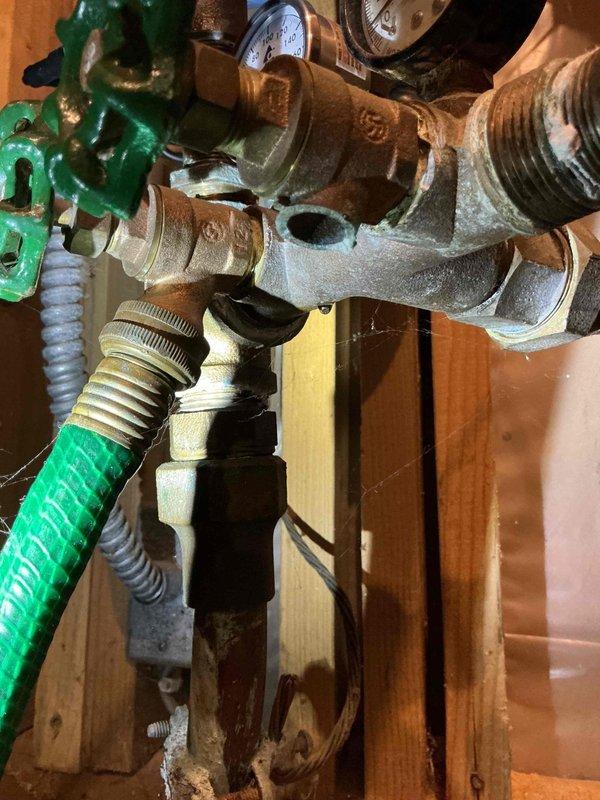 Responded to service call for reported water condensation behind furnace. Upon thorough inspection of HVAC equipment and surrounding area, determined that moisture issue was unrelated to heating or cooling systems. Identified source of water leak as faulty pressure gauge on main water supply line. Documented plumbing components with photos and recommended scheduling licensed plumber to address water line issue.