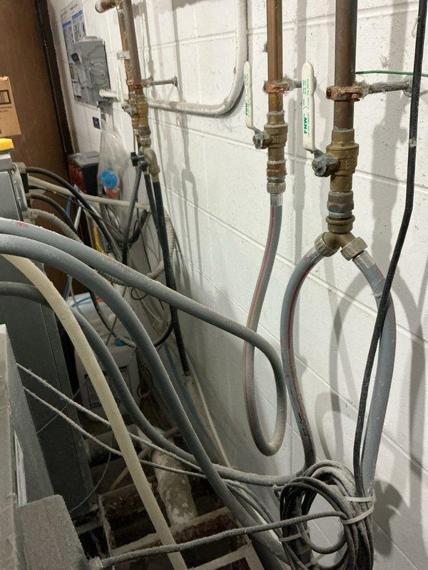 Performed City of EC cross connection and backflow prevention inspection. Identified non-compliant Hydro FM 804 chemical mixing device lacking ASSE certification. Documented existing backflow assembly condition showing significant aging and corrosion on brass valves and fittings. Advised that chemical mixing company must replace non-certified device before reinspection can be completed.