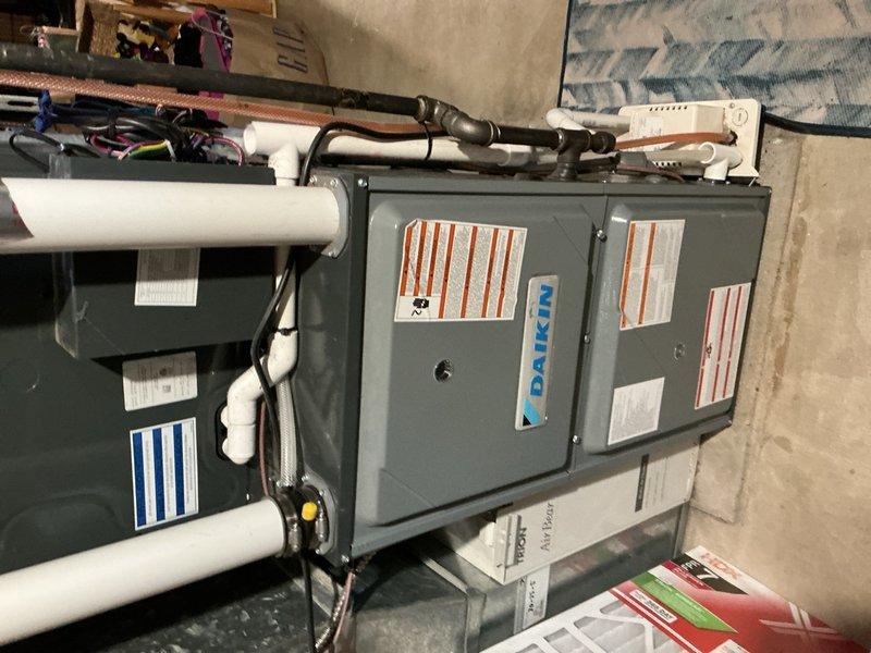Replaced failed inverter control board on Daikin mini-split outdoor unit under parts and labor warranty. Disassembled control panel housing, removed defective PCB, and installed new inverter board. Set thermostat to test mode to verify proper communication between indoor and outdoor units. Conducted operational testing confirming outdoor unit functionality and measured 20-degree delta-t across the system, indicating proper cooling performance. System restored to full operation with all components functioning within normal parameters.