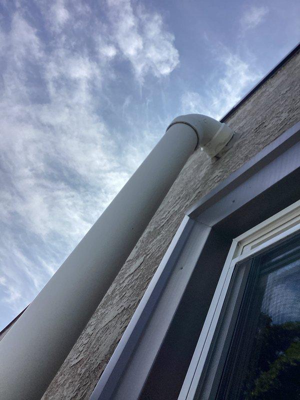 Responded to a ceiling leak caused by a failed roof drain coupling on a PVC drain pipe system servicing a flat roof. Upon inspection, water damage was evident in the interior ceiling with visible staining and deterioration of building materials. Disassembled the compromised roof drain coupling, properly cleaned and re-primed all mating surfaces, and reinstalled the coupling with PVC solvent cement applied to full depth to ensure a watertight seal and prevent future leakage.
