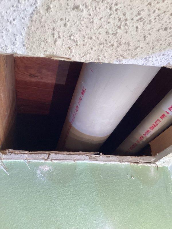 Responded to report of mystery water leak with thumping sound, suspected plumbing pipe leaking onto ductwork. Investigated ceiling leak by creating access openings to inspect area. Found evidence of active water leak affecting ceiling and structural components, but unable to determine exact source location without additional investigation. Observed PVC piping, wooden structural beams, and insulation within ceiling cavity. Documented conditions with photographs. Due to homeowner's unavailability until following Monday, shut off main water supply to home to prevent further damage. Follow-up visit scheduled upon homeowner's return to utilize inspection camera equipment, pinpoint exact leak location, and complete necessary repairs.