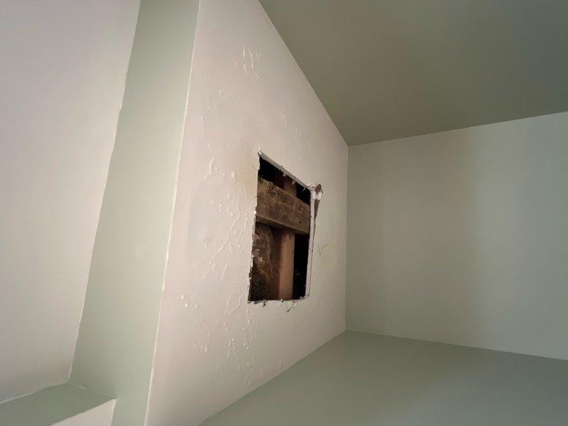 Responded to main floor toilet leak causing water damage to basement ceiling below. Upon inspection, confirmed water dripping into basement when toilet was flushed. Diagnosed leak originating from toilet base or wax ring seal. Created access opening in basement ceiling drywall to assess extent of water damage and identify leak source from above. Documented water staining on wooden framing members and structural components. Provided estimate for toilet removal, wax ring replacement, flange inspection, and reinstallation to resolve active leak and prevent further water intrusion.