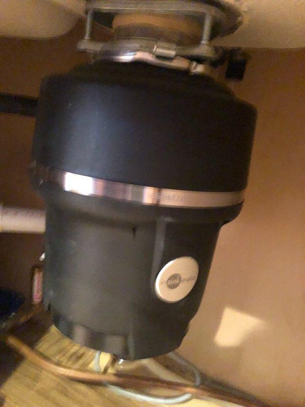 Responded to service call for malfunctioning garbage disposal unit. Upon inspection, found one cutting knife jammed, causing reduced performance. Presented repair option to customer, who opted for full unit replacement. Removed existing disposal and installed new InSinkErator Pro Disposer 3/4 HP unit with electrical cord. Secured mounting assembly to sink drain opening, verified all connections, and tested operational functionality. Confirmed proper grinding performance and inspected all plumbing connections for leaks with no issues detected.