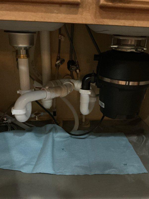Completed kitchen faucet replacement over two service visits. During the first visit, disconnected existing kitchen sink plumbing and prepared the workspace for new fixture installation. Returned the following day to install customer-supplied kitchen faucet, reconnected all sink plumbing including drain assembly and P-trap configuration, and verified proper operation of the disposal unit connections. All work completed per the original estimate with no leaks detected upon final inspection.