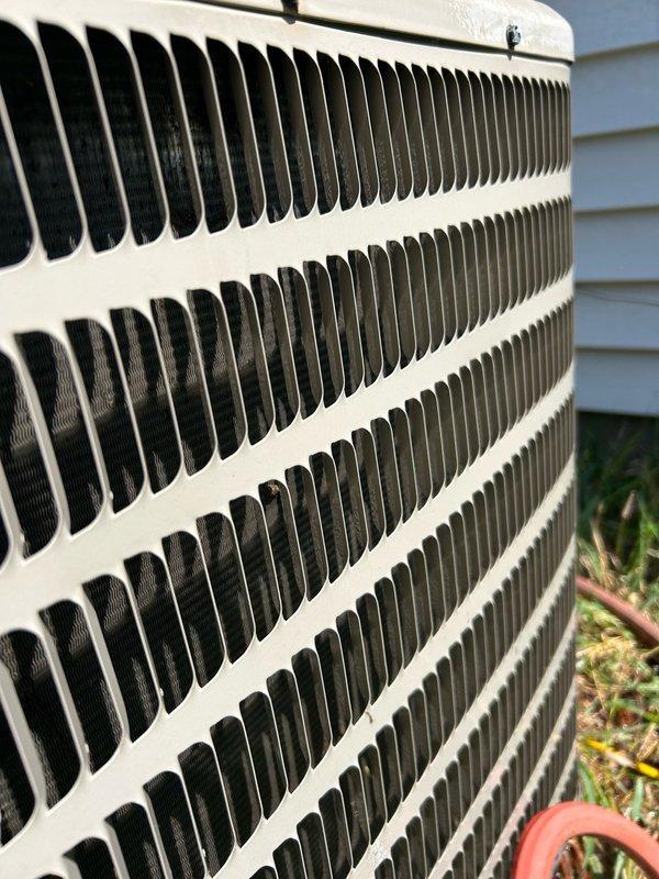 Completed annual cooling maintenance on a standard residential air conditioning system with air exchanger located in attic space. Performed comprehensive spring tune-up inspection including thermostat operation verification, air filter assessment, blower assembly examination, outdoor condenser coil inspection, electrical component testing, contactor and capacitor evaluation, condensate drain line check, refrigerant charge analysis, and temperature split measurements. All system readings fell within manufacturer specifications with no mechanical defects or safety hazards identified. System confirmed to be operating at optimal performance levels. Documented outdoor condenser unit condition showing normal weathering and minor debris accumulation in coil fins. Observed plumbing components beneath fixture during service visit, noting corrosion on metal fittings and rust staining on PVC drain piping. Advised routine filter replacement, regular coil cleaning maintenance, and continued adheren