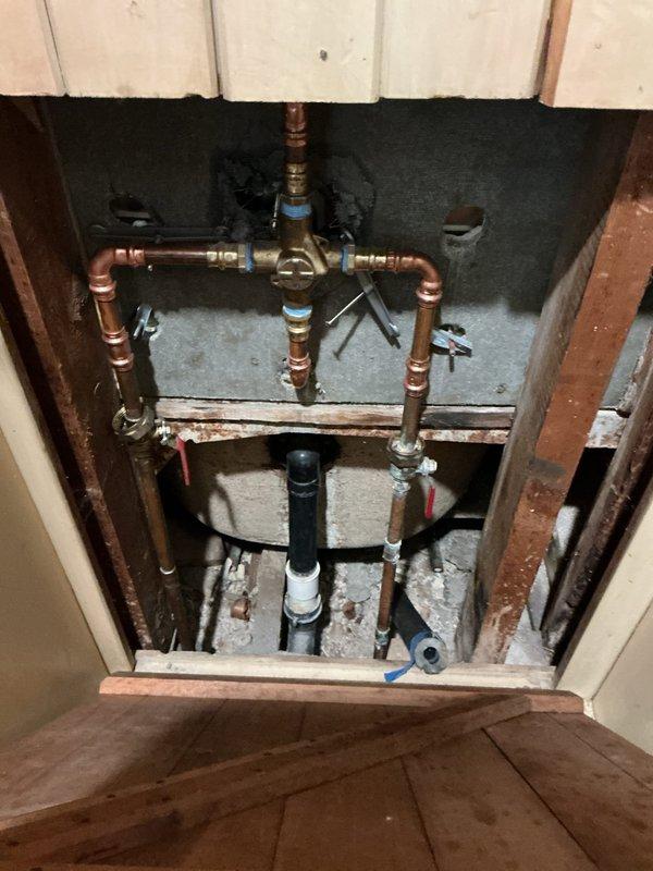 Installed waterline supply for refrigerator connection with appropriate shutoff valve and compression fittings. Upgraded tub/shower valve system with Moen T2133/2520 trim kit in brushed nickel finish, including new spout and showerhead assembly. Installed chrome push pop-up drain assembly for main floor bathroom sink, ensuring proper operation and seal.