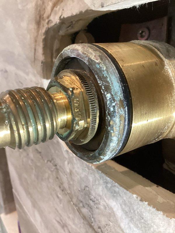 Responded to service call for shower volume control issues. Accessed shower valve assembly through tiled bathroom wall opening. After initial assessment, contacted Grohe technical support to verify correct replacement parts specifications. Corrected parts sourcing and supplied two new Grohe shower volume control cartridges. Removed existing cartridges showing mineral deposits and corrosion. Installed replacement cartridges into brass valve bodies. Tested both shower controls for proper volume regulation and operation. Inspected all connections for leaks. Cleaned work area and removed debris. System restored to full functionality with one-year parts and labor warranty provided.